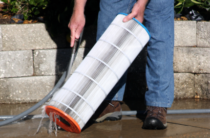 Pool cleaning company cleaning a pool filter in Gulf Breeze, FL